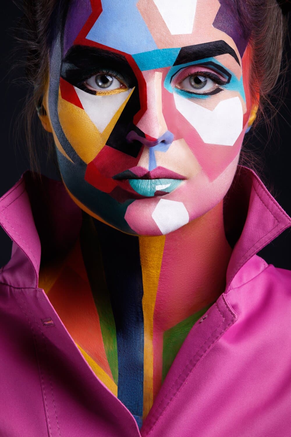 Face painted in flat geometric colour blocks